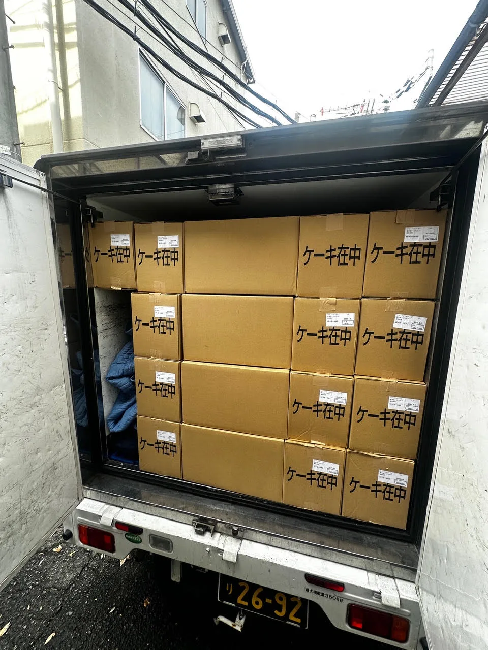 箱が整然と積まれた冷蔵軽貨物の荷室